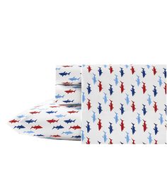 three sheets with red, white and blue sharks on them are folded up in front of each other