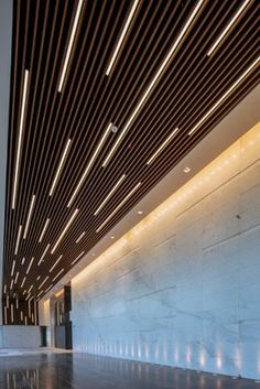 an empty lobby with lights on the ceiling