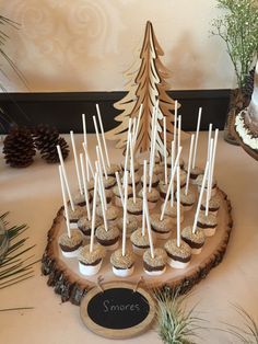 small cupcakes are arranged in the shape of a christmas tree on a wood slice