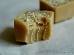 two pieces of soap sitting on top of white paper