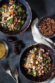 three bowls filled with different types of food next to spoons and utensils