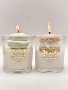 two candles sitting next to each other on top of a table