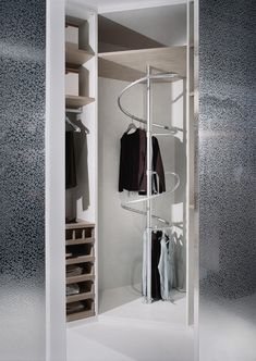 an open closet with clothes hanging in it