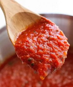 a wooden spoon full of marinara sauce