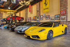 a row of sports cars parked in a garage