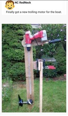 an image of a driller on top of a wooden pole in the grass with another tool attached to it