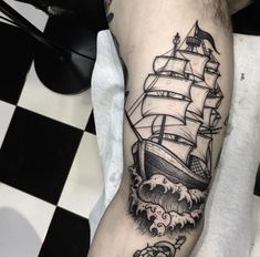 a man's arm with a ship on it