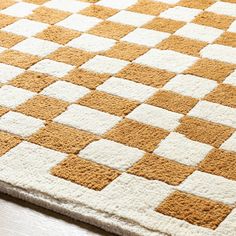 an orange and white rug with squares on it