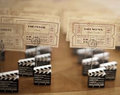 some sort of movie ticket sitting on top of a wooden table next to each other