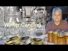 a woman sitting in front of some jars filled with gold rings and snowflakes