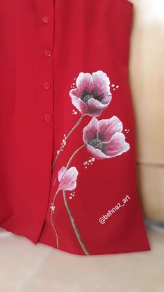 a red jacket with pink flowers painted on it