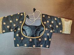 Stunning black designer sari blouse with golden floral embroidery. Shop designer saree blouse online in USA from Pure Elegance. Disclaimer: The actual product may vary slightly from the image. These are custom orders, hence expect slight variation in color, placement of the motif or buta. ESTIMATED DELIVERYBecause this is a custom order, it would take about 2 weeks from the date of purchase. RETURN POLICY: This product is a custom order and cannot be returned or exchanged. Semi-stitched Black Art Silk Blouse Piece, Black Cutdana Blouse For Reception, Black Art Silk Saree Blouse Piece, Designer Embroidered Black Saree, Black Embroidered Anarkali Saree, Designer Art Silk Black Blouse Piece, Designer Black Art Silk Blouse Piece, Black Art Silk Blouse Piece With Resham Embroidery, Black Bollywood Embroidered Saree