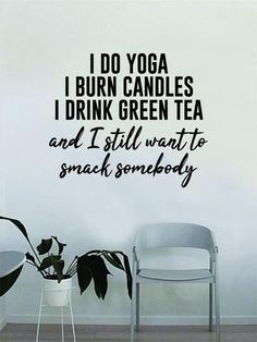 i do yoga wall decal in black on a white wall next to two chairs and a potted plant