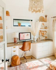 a room with a desk, chair and rug in it