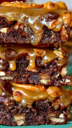 three brownies stacked on top of each other with caramel pretzel toppings