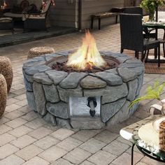 a fire pit sitting on top of a brick patio