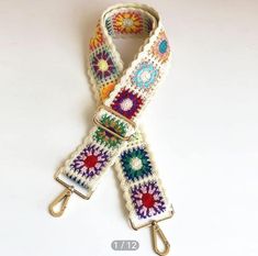 a white crocheted belt with multicolored flowers on it