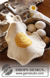 an egg in a basket next to eggs on a table