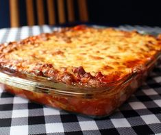 a casserole dish is sitting on a checkered tablecloth