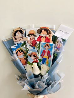 someone is holding a bouquet with some pictures on it