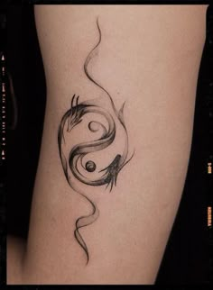 a woman's thigh with a black and white tattoo design on the side of her leg