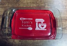 there is a red tray that has a fork and spoon on it with the words terri's kitchen