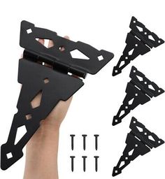 four pieces of black plastic with holes and screws in the middle, one being held up by a hand