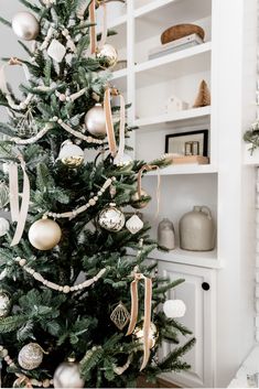 a christmas tree decorated with gold and silver ornaments