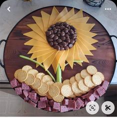 a cake made to look like a sunflower with crackers and chocolate chips on it