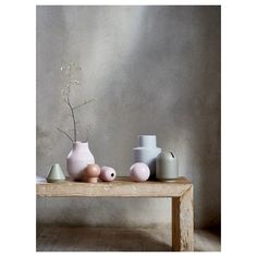 three vases are sitting on a wooden table