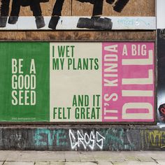 graffiti on the side of a building with posters and words written in different languages, including i've got my plants and it felt great