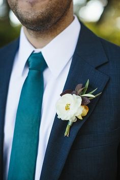 a man in a suit with a flower on his lapel