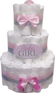 a baby girl diaper cake with pink and blue ribbons on it's sides