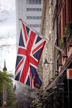 an union jack flag hanging from the side of a building