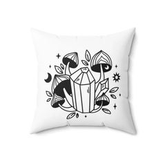 a black and white pillow with an image of two mushrooms on top of the pillow