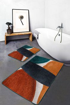 a bath tub sitting next to a bathroom rug