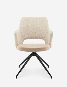 an upholstered chair with a black metal base and beige fabric on the back