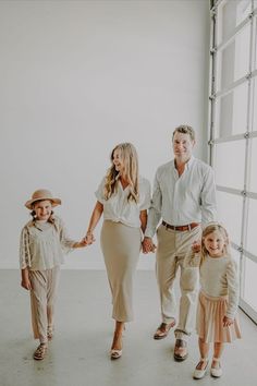 a family holding hands and walking in an empty room