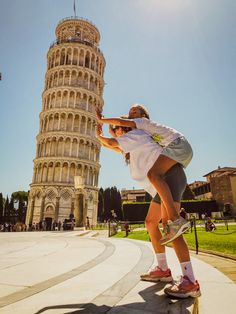 a person on a skateboard in front of the leaning tower