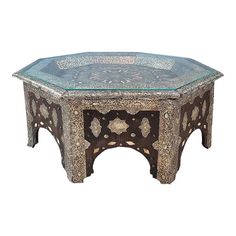 an intricately designed coffee table with glass top