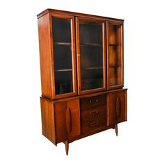 a wooden cabinet with glass doors and drawers on the front, against a white background