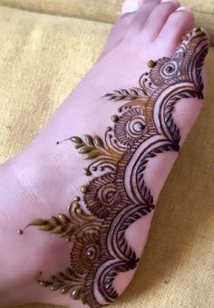 the foot is decorated with henna on it