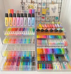 a display case filled with lots of different colored pens and marker pens on top of each other