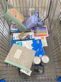 a shopping cart filled with lots of crafting supplies on top of a carpeted floor