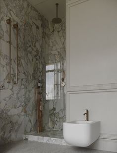 a bathroom with marble walls and flooring