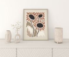 a white shelf with vases and an art print on it's sideboard