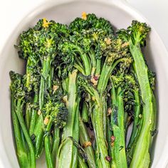 a white bowl filled with broccoli and green beans