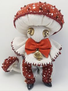 a stuffed animal with a red bow tie and white polka dots on it's head