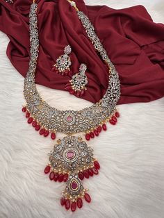 AD Red Stone Red Beads Dual Polish Long Necklace with screw back  earrings Victorian finish gives diamond look to the necklace. Fine quality and craftmanship. Premium quality. Ideal for desi weddings, House warmings baby showers. It has an adjustable cord(dore) back thread hence can adjust length. Necklace Length : 24 Inches Approx. Earring Length : 2 inches; Screw Back Ready to ship from Massachusetts, USA If you have any questions please let me know. Festive Red Ruby Jewelry, Red Ruby Jewelry With Intricate Design, Luxury Red Ruby Jewelry With Intricate Design, Hand Set Red Kundan Ruby Necklace, Festive Red Jewelry With Intricate Design, Red Round Beads Stone Jewelry, Red Stone Jewelry Sets For Gift, Red Jewelry With Round Beads And Stones, Red Jewelry With Elegant Design For Celebration