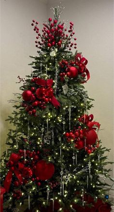 a decorated christmas tree with red ornaments